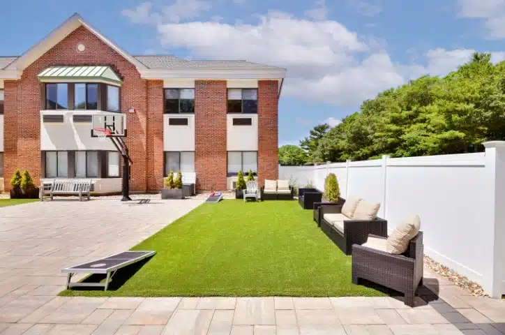 Outdoor recreation area with seating and a basketball hoop.