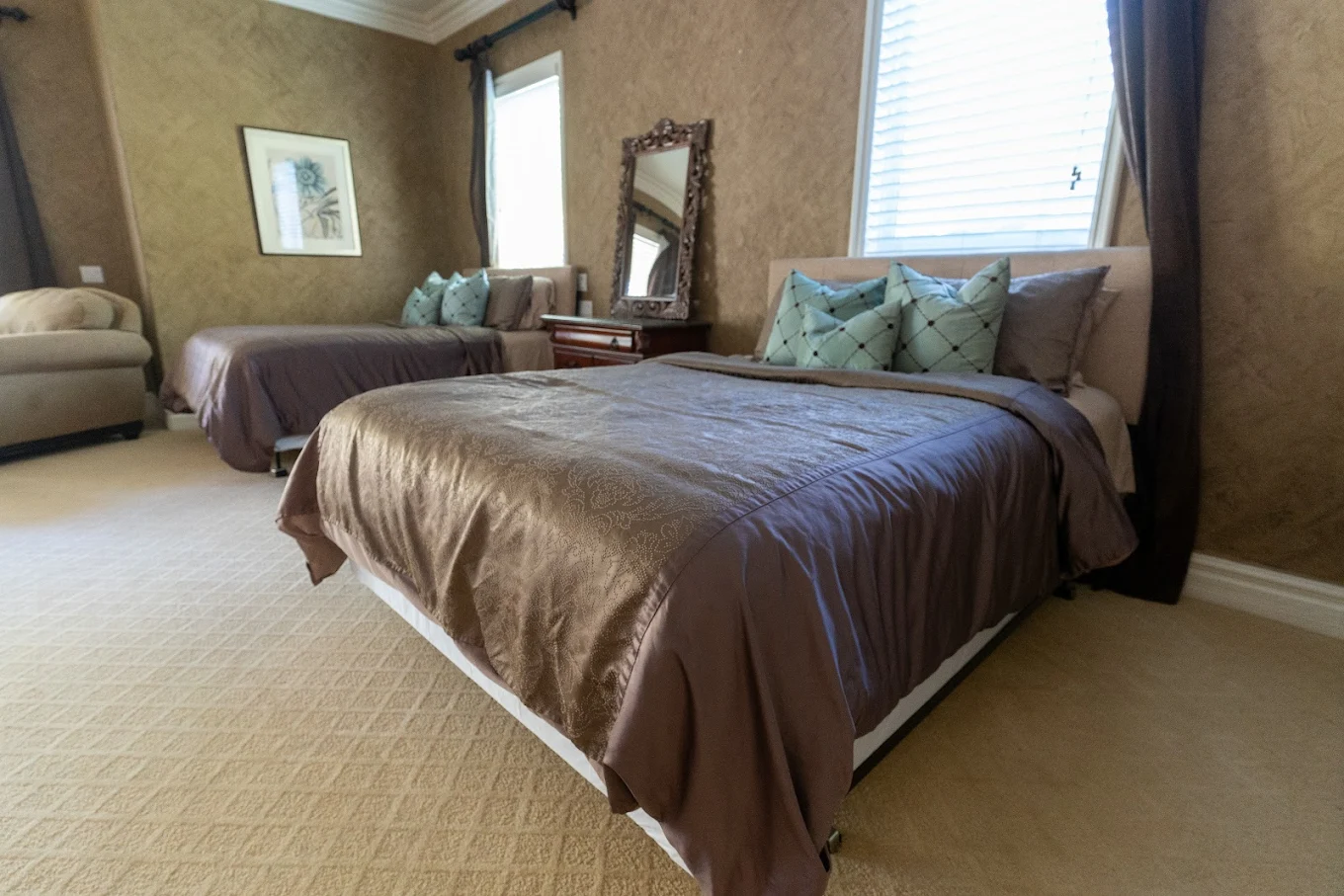 Spacious room with two beds and decorative pillows