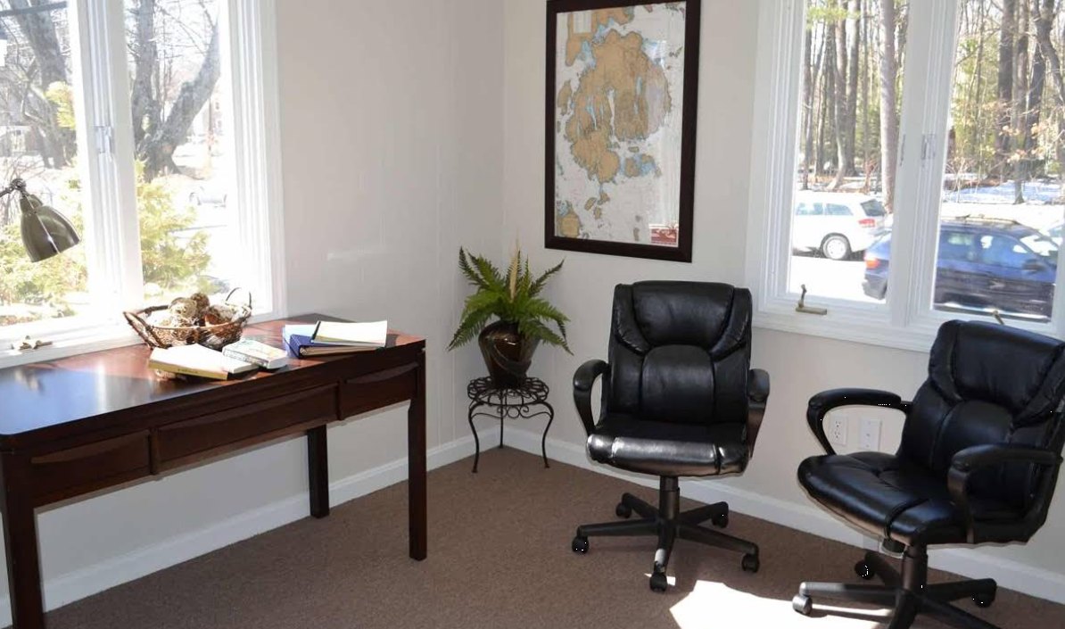 Counseling office with desk, chairs, and natural light
