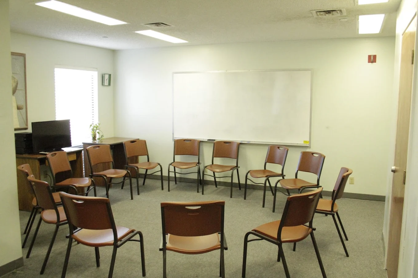 Circle of chairs arranged for group therapy.