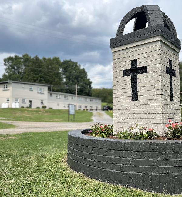 Brick monument with crosses near front lawn
