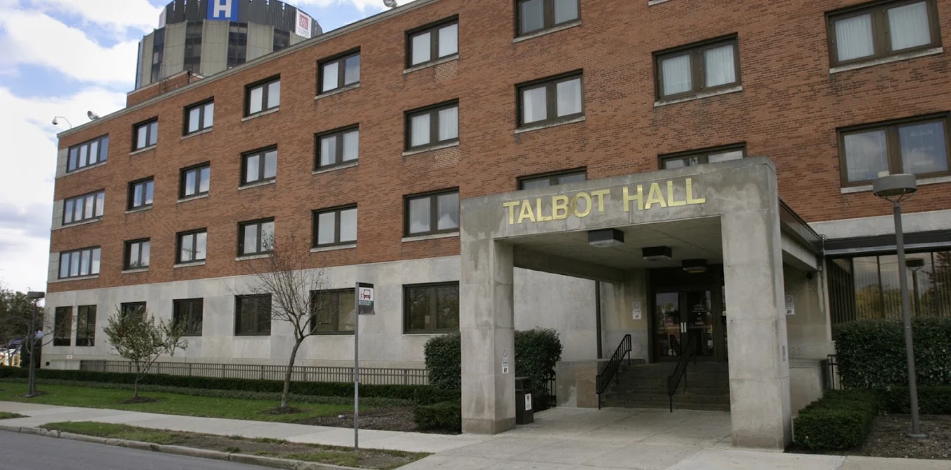 Brick Talbot Hall building with covered front entrance