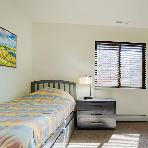 Single bed with window and nightstand