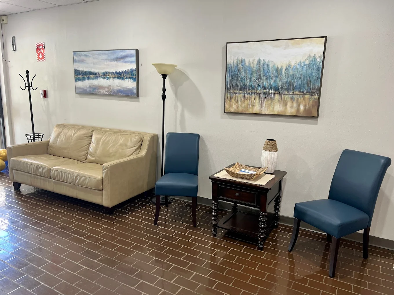 Tan sofa and blue chairs in a quiet hospital lounge