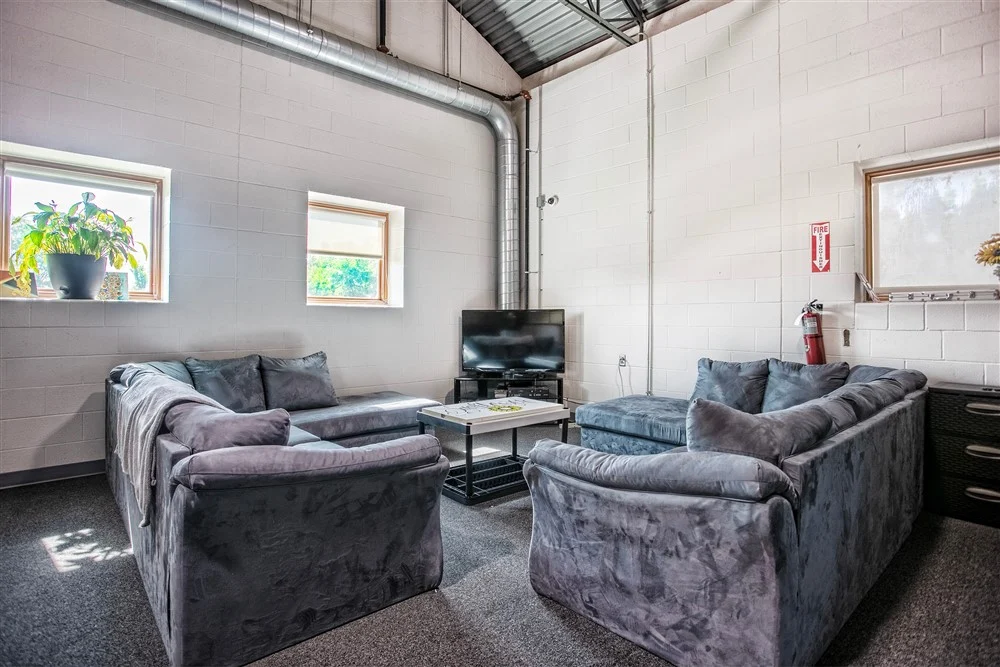 Lounge area with couches and television for residents