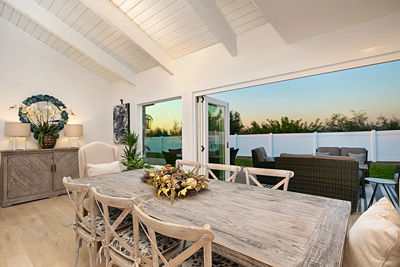 Large dining room with table overlooking outdoor patio