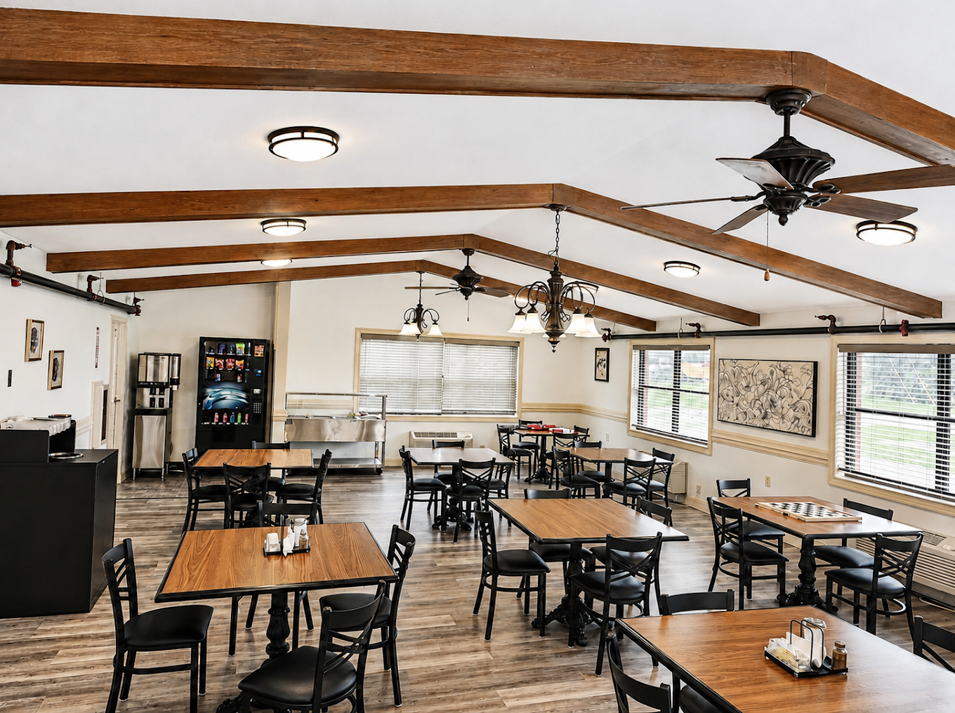 Spacious dining area with tables, chairs, and exposed beams